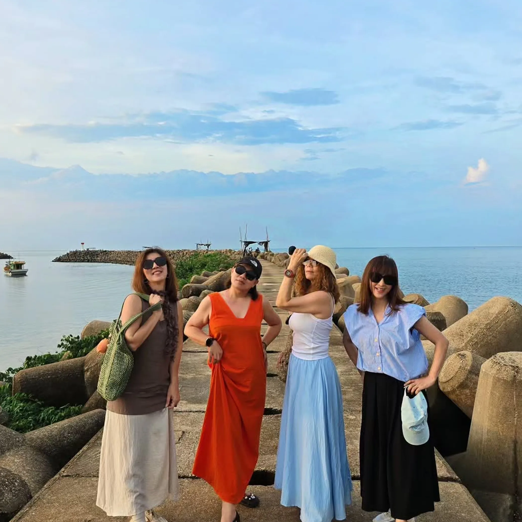 travelers on seaside breakwater
